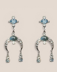 D by Dalia Jewelry silver-tone chandelier drop earrings with icy blue crystals and crescent-shaped pavé accents.