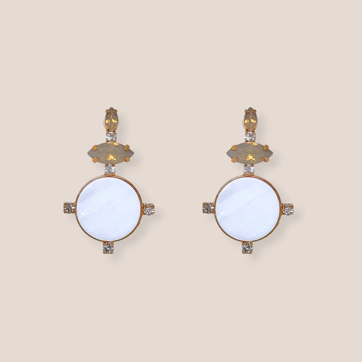 d-by-dalia-jewelry circular drop earrings featuring white discs, faceted neutral stones, and gold-tone crystal accents