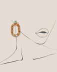 d-by-dalia-jewelry oval link statement earrings in gold-tone with a turquoise crystal accent on a line art illustration