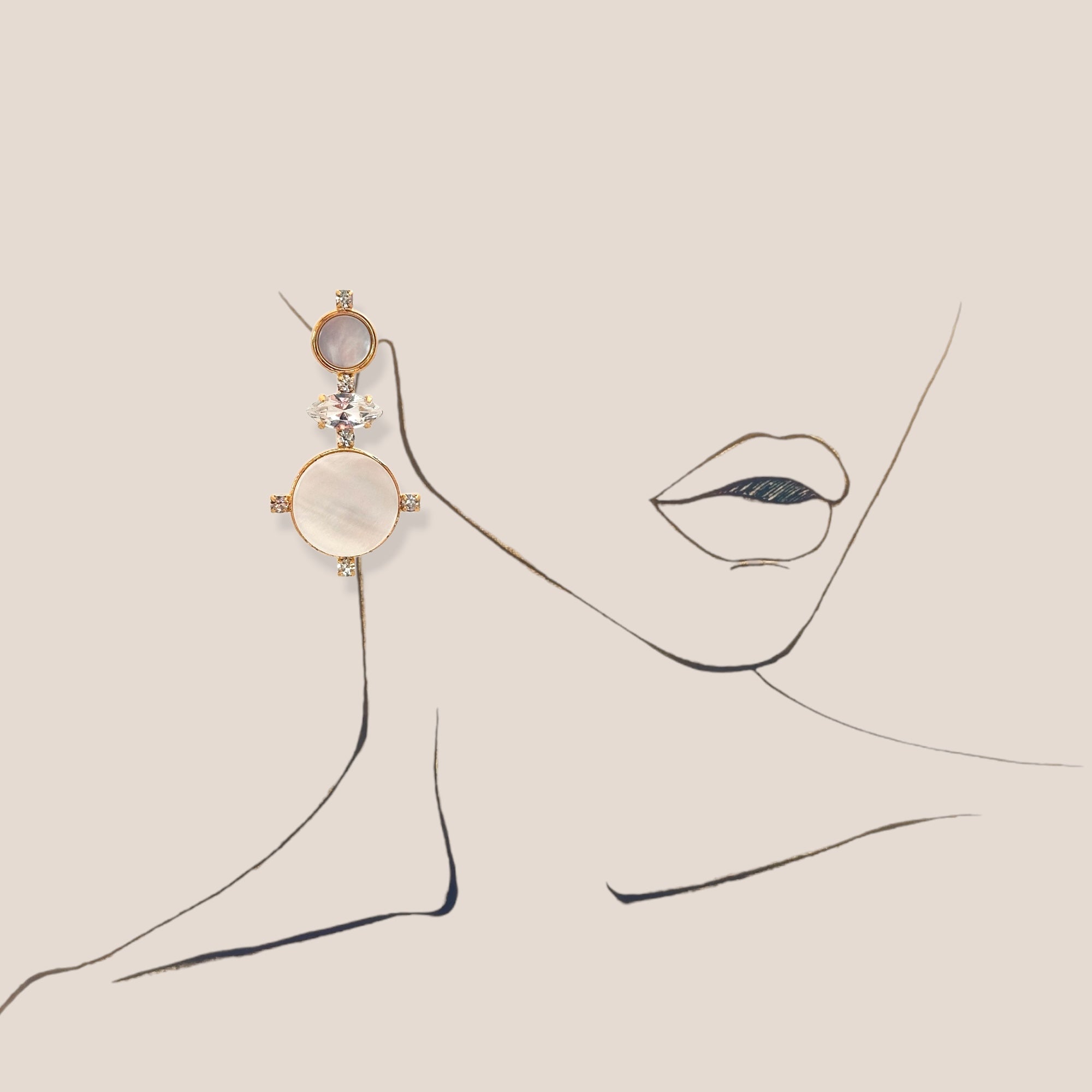 d-by-dalia-jewelry gold drop earrings featuring iridescent mother-of-pearl and crystal accents on a line art portrait