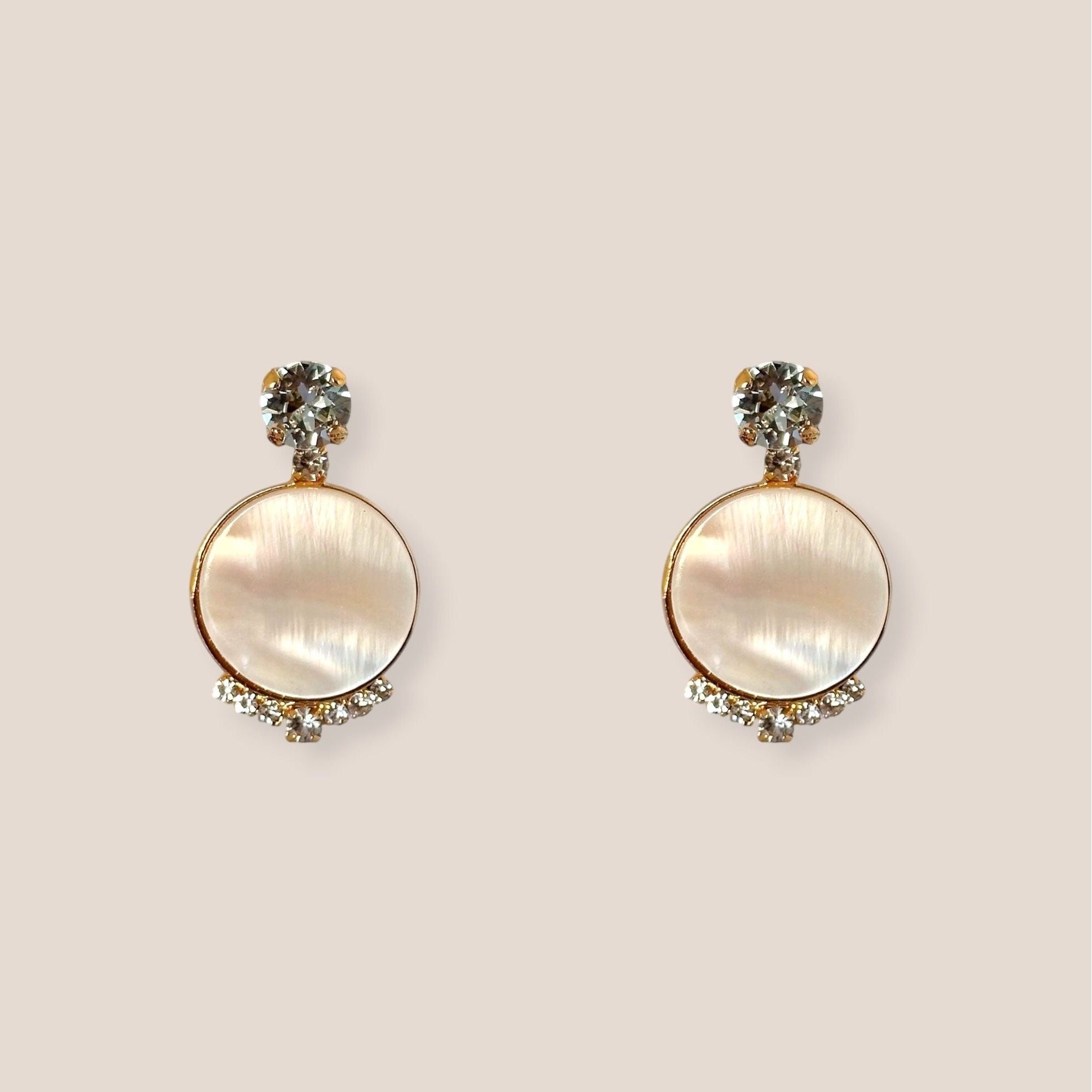 d-by-dalia-jewelry round mother-of-pearl drop earrings with gold setting, crystal accents, and stud backings.