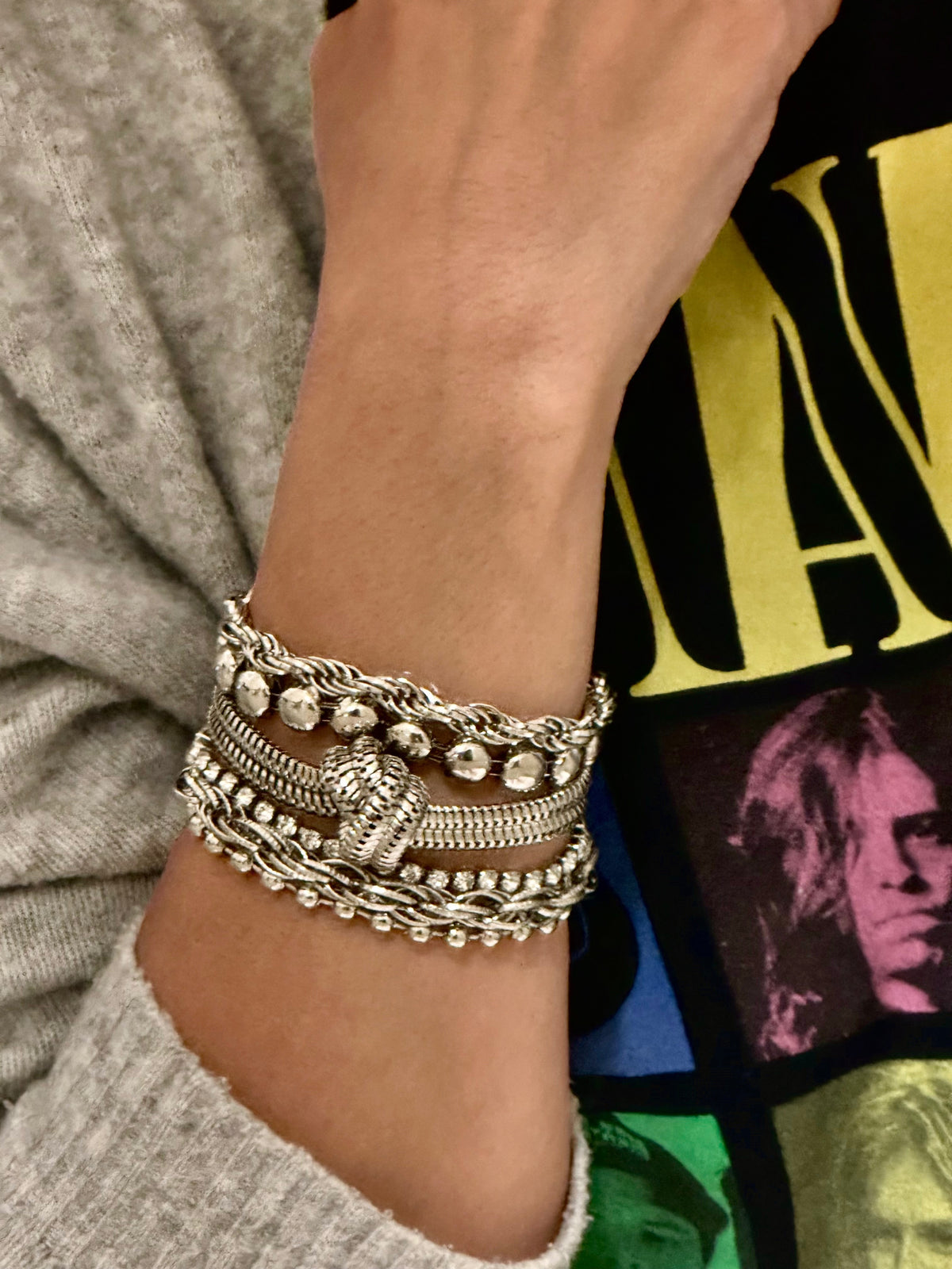 d-by-dalia-jewelry multi-layered silver-tone chain bracelet with knotted detail and mixed textures on a wrist