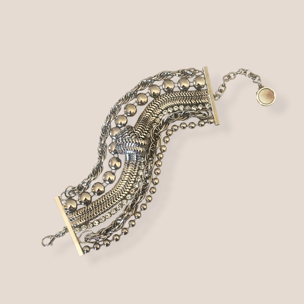 d-by-dalia-jewelry multi-layered silver-tone chain bracelet with beaded strands, snake chain, and knotted detail.